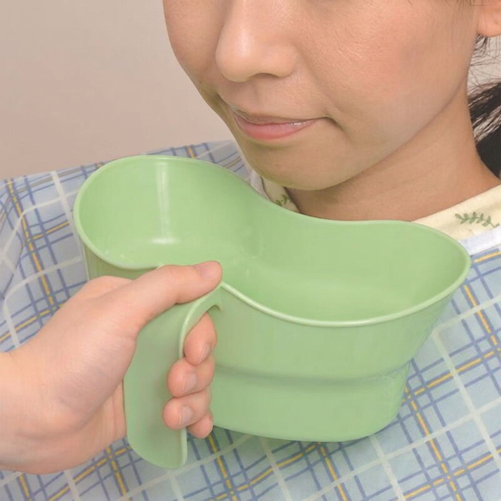 LMXA Comfort-Curve Bedside Rinse Cup held to chin in use